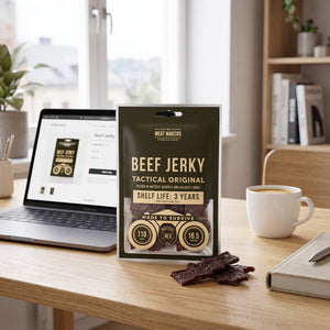 Meat Makers Tactical Beef Jerky Original på skrivebordet ved siden av laptop, kaffekopp og notatbok, AI-generert bilde