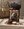 Indiana Beef Jerky Original på et trebord ved en ryggsekk, med jerkybiter og en skål salt, AI-generert bilde