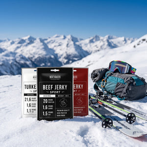 Meat Makers Sports Beef Jerky Pakkepris i snøen ved siden av turski og staver på en solrik vinterdag i fjellet, AI-generert bilde